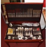 A 20th century Tudor Crown canteen of Kings pattern flatware, housed in a mahogany case with green