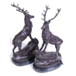 A pair of bronze models of stags, each shown standing upon a naturalistic base, further mounted upon