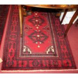 A Turkish woollen red ground Turkeman rug, 200 x 113cm