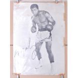 A large black and white poster of World Heavyweight Champion Muhammed Ali, Printed boldly in black