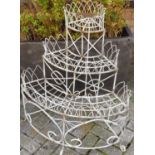 A painted wired metal garden corner three-tier graduated plant stand