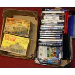 Two small boxes containing two boxed model tanks by Marx; and a collection of games and DVDs to