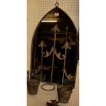 A contemporary galvanised metal lancet arched garden wall mirror, having floral detail to