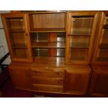 An Ercol elm Windsor range wall cabinet, the modular upper section having twin glazed doors, open