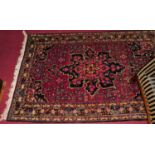 A Persian woollen red ground Tabriz rug, 175 x 110cm