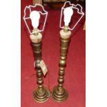 A pair of Eastern engraved brass table lamps, of turned and notched form, h.75cm (excluding