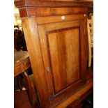 An early 19th century oak and mahogany crossbanded single door hanging corner cupboard, height 106.