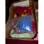 A box of loose Meccano plastic cogs and wheels, and other parts