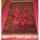 A Persian red ground woollen small Bokhara rug, having flatweave ends, 160 x 109cm