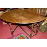 An 18th century joined oak dropleaf dining table, the oval fall leaves with gateleg action and