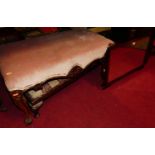 A 19th century floral carved mahogany twin dressing stool, with pink dralon upholstered seat, length