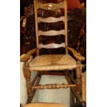 A 19th century elm and fruitwood rush seat ladder back rocking armchair, together with a further