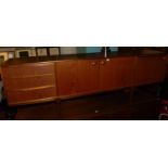 A.H. McIntosh & Co - a 1960s teak long sideboard, having twin central cupboard doors flanked by