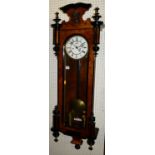 A late 19th century figured walnut and ebonised Vienna regulator wall clock, having glazed long