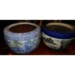 Two similar contemporary Chinese painted stoneware circular planters, each decorated with mountain