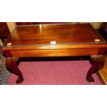 A contemporary small mahogany low occasional table on cabriole supports, width 68cm