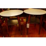 A pair of 1950s formica topped circular two-tier stained beech occasional tables, dia. 55cm