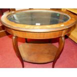 An early 20th century mahogany and floral inlaid oval hinged glazed top two-tier bijouterie table,