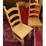 A set of six contemporary pine panelled seat ladderback dining chairs