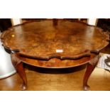 A mid-20th century figured walnut piecrust topped circular low occasional table, dia.73cm