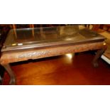 An Eastern relief carved camphor wood rectangular coffee table, length 99cm