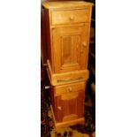 A pair of modern pine single door bedside cupboards, each having single upper drawers, width 38.5cm