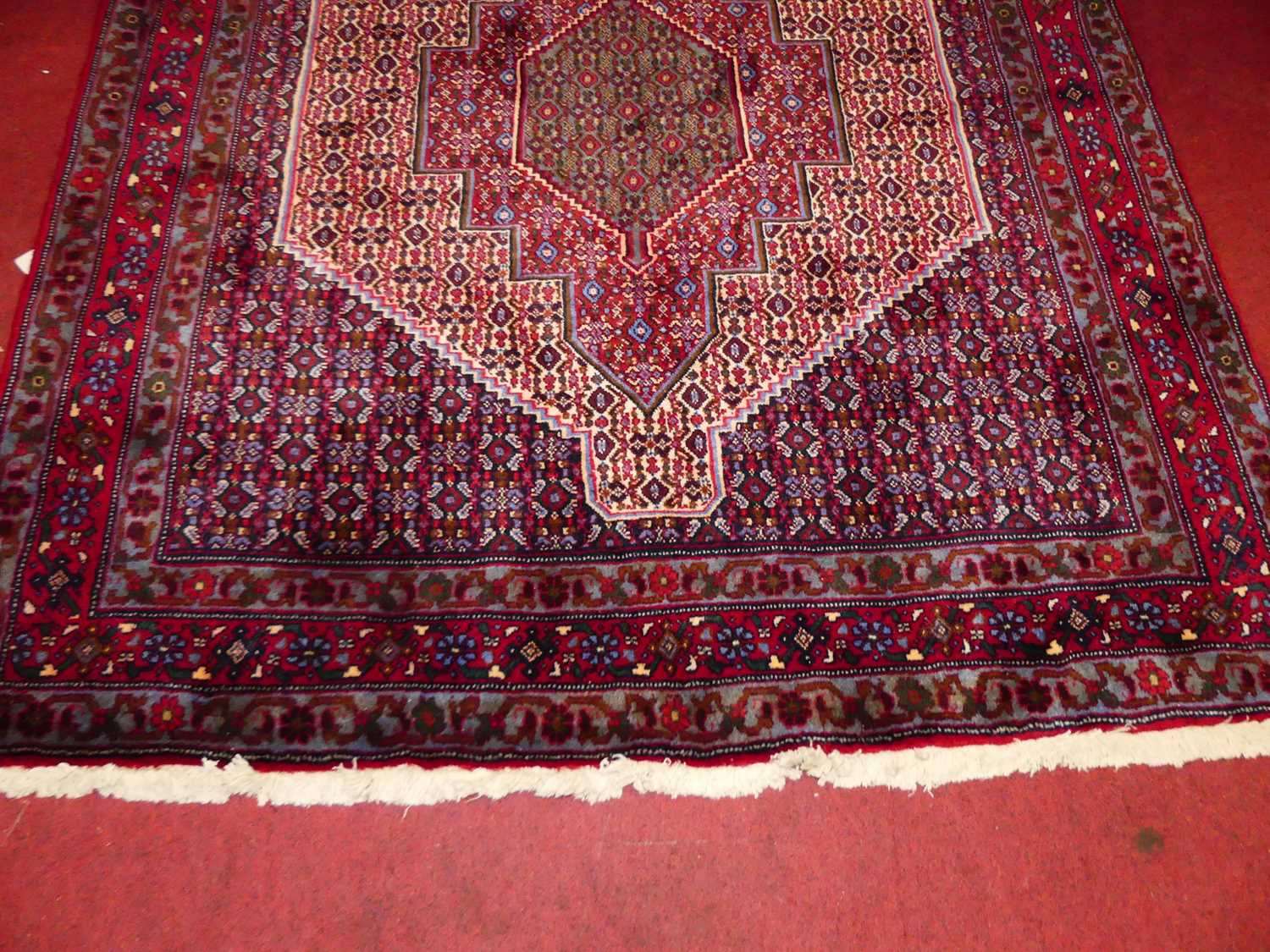 A Persian woollen red ground Senneh rug, 150 x 128cm - Image 2 of 5