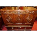 An antique joined and floral relief carved oak three panelled hinge top coffer, width 102.5cm