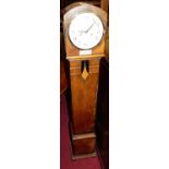 A 1930s oak granddaughter clock, with pendulum and winding key, h.138cm