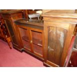 A Victorian mahogany inverted breakfront side cabinet, having twin central glazed doors flanked by
