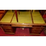 A circa 1900 mahogany and green leather inset twin pedestal partner's desk, having an arrangement of