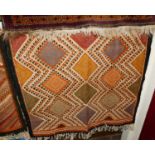 A matched pair of Tunisian woollen bright coloured decorated rugs; together with a striped machine-