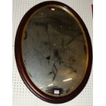 A reproduction mahogany oval wall mirror, 76 x 59cm