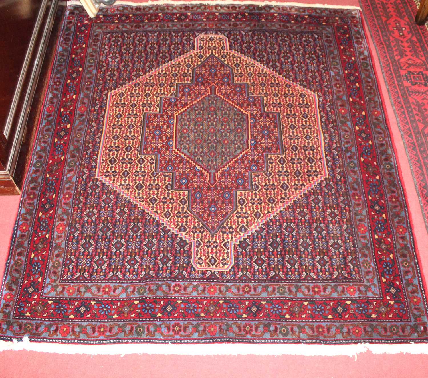 A Persian woollen red ground Senneh rug, 150 x 128cm