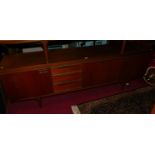 A 1960s teak long sideboard by Greaves & Thomas, having three drawers and a single central fall-