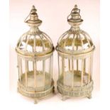 A pair of modern painted metal outside hanging lanterns, each having a domed top and glass body,