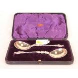 A pair of Edwardian silver anointing spoons, each having a shallow bowl with spirally turned stem,