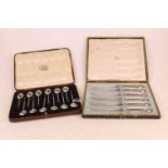 A set of twelve mid-20th century silver coffee bean spoons, in fitted leather case; together with