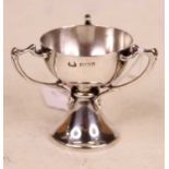 A small Edwardian silver cup, having three shaped handles and on domed foot, 1.8oz