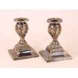 A pair of Victorian silver plated dwarf table candlesticks, relief decorated in the Neo-Classical