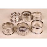 A collection of six Victorian and later silver napkin rings; together with a silver plated