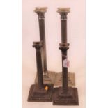 A pair of modern silver plated table candlesticks, each having a Corinthian capital on a fluted