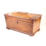A late Regency mahogany rosewood tea caddy, of sarcophagus form, the hinged lid opening to reveal