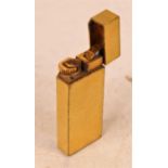 A Cartier textured gold plated cased pocket cigarette lighter, numbered 91688K