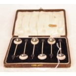 A set of six George V silver coffee bean spoons, in fitted leather case