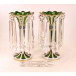 A pair of late 19th century Bohemian green glass table lustres, each of trumpet shape, etched and