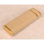 A Cartier pocket cigarette lighter, the cream case with gilt banding, numbered 27606G