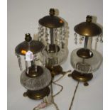 A pair of table lamps, each having a domed top with glass prism drops above a clear glass font, on