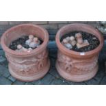 A pair of contemporary figural decorated terracotta circular planters, each dia. 44cm, height 39cm