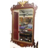 A large early 20th century Chippendale style fret carved mahogany wall mirror, having gilded eagle